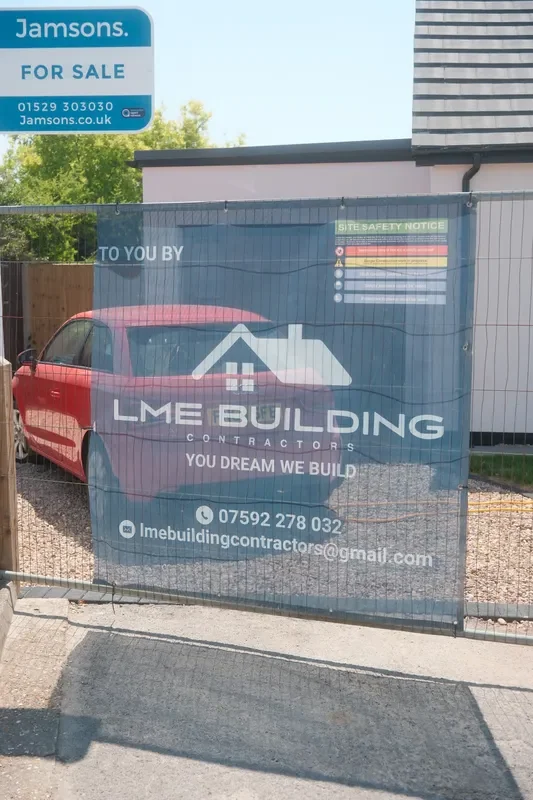 LME Building site banner on temporary fencing outside a residential property