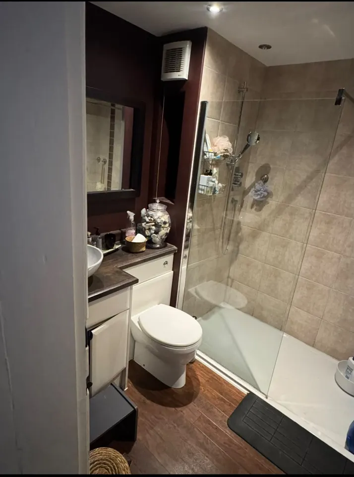 Completed Ewerby wet room with vanity unit, toilet and glass shower screen