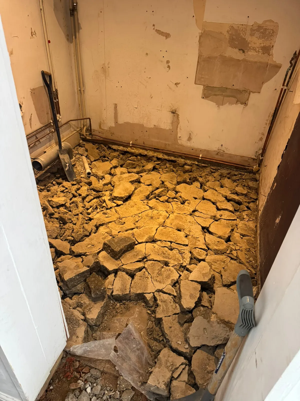 Broken floor material during preparation for the Ewerby accessible wet room