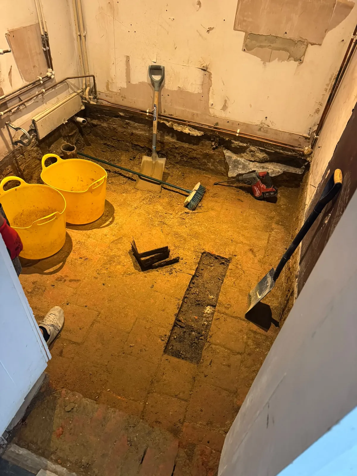 Floor excavation with hand tools and rubble tubs in the Ewerby bathroom