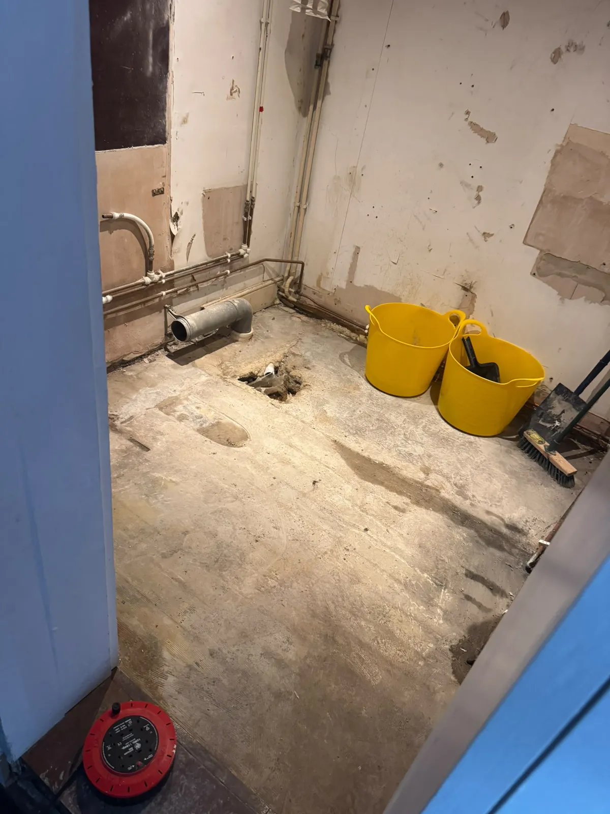 Stripped bathroom with exposed pipework and an opening in the floor in Ewerby