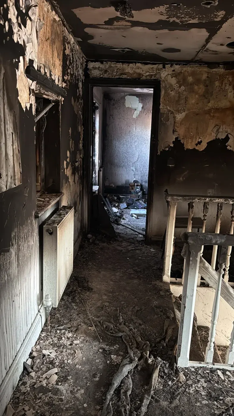 Smoke-darkened hallway in the Holbeach flat before renovation