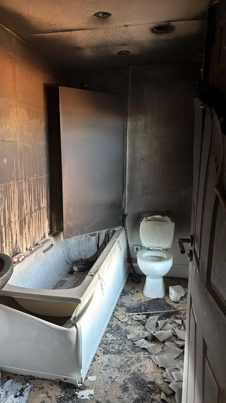 Smoke-damaged bathroom in the Holbeach flat before renovation