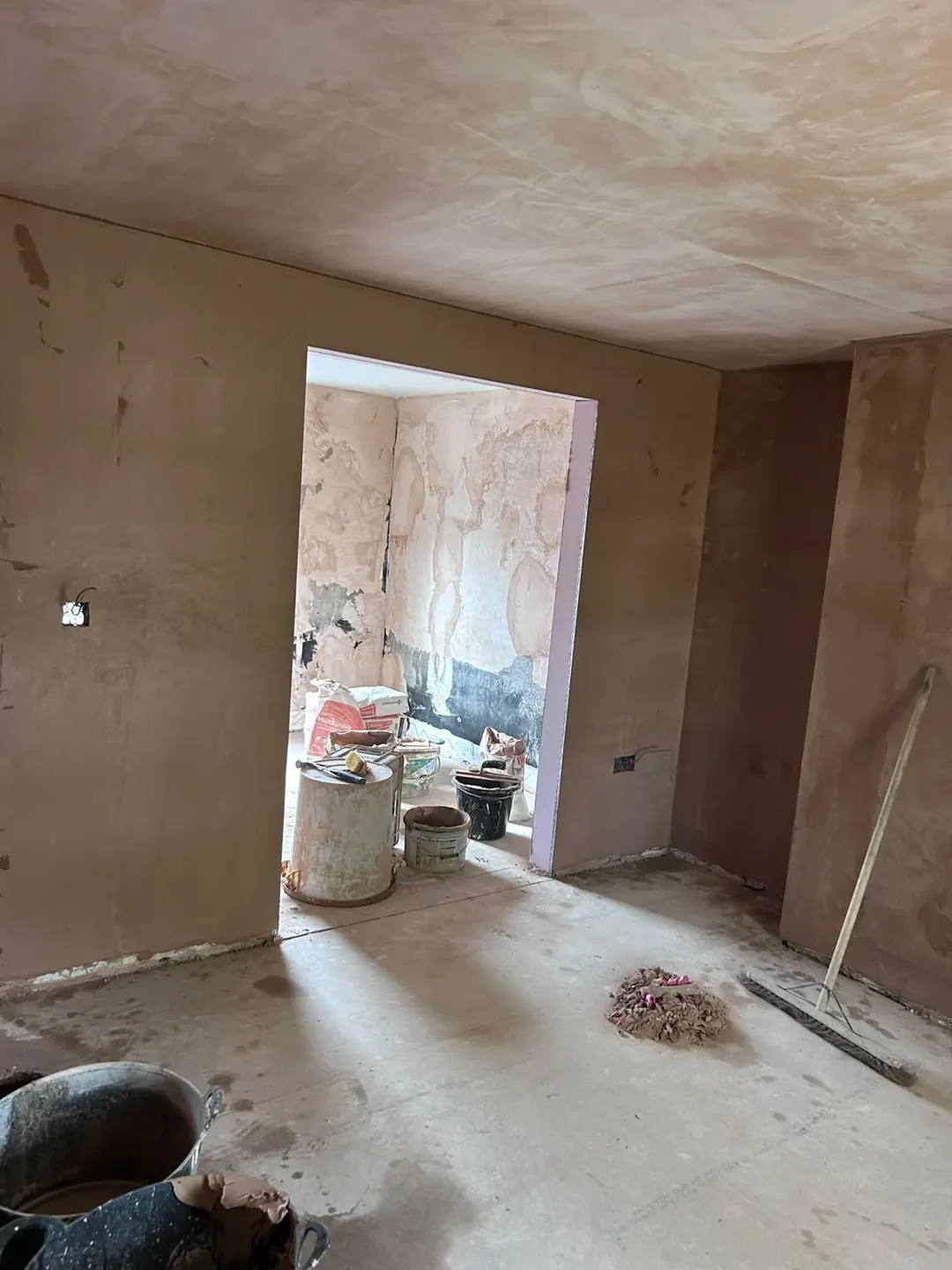 Freshly plastered walls and ceiling in the Holbeach flat before decoration