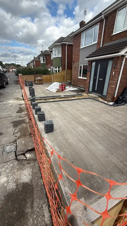 Concrete driveway in Lincoln with dark block edging being fitted