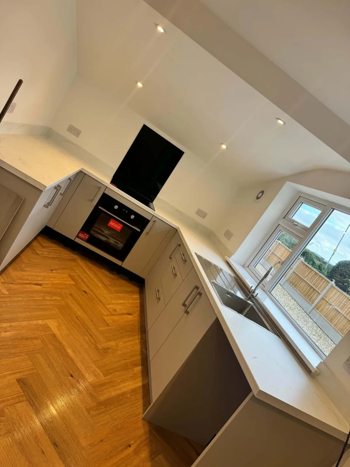 Fitted kitchen and herringbone-pattern flooring in the Bassingham property