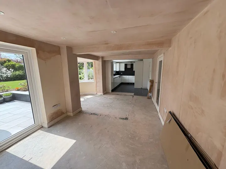 View through plastered living rooms towards the kitchen in Grantham