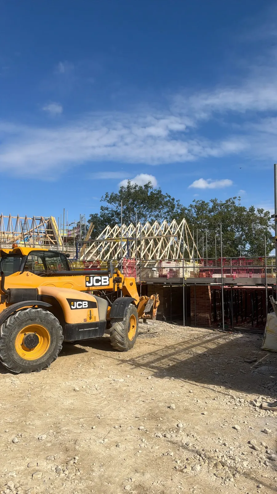 Timber roof trusses and lifting equipment at a building site in Leasingham
