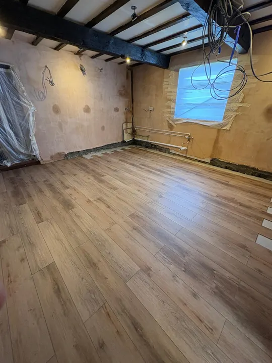 Plastered walls and plank-pattern flooring before kitchen cabinets were fitted in Sleaford